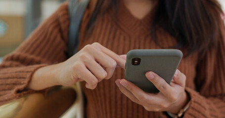 Woman use of mobile phone at shopping mall