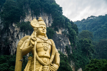 Fototapeta na wymiar Gigantic statue of Murugan, at the entrance of the Batu Caves temple in Kuala Lumpur, Malaysia