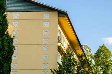 Yellow facade with patterns of an apartment building