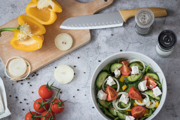 Green vegan salad made from a mixture of green leaves and vegetables.