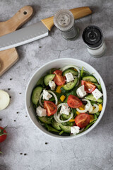 Green vegan salad made from a mixture of green leaves and vegetables.