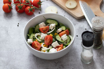 Green vegan salad made from a mixture of green leaves and vegetables.