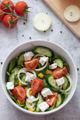 Green vegan salad made from a mixture of green leaves and vegetables.