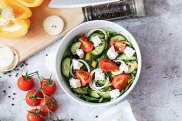 Green vegan salad made from a mixture of green leaves and vegetables.