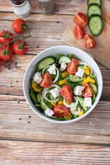 Green vegan salad made from a mixture of green leaves and vegetables.