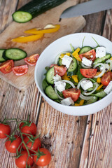 Green vegan salad made from a mixture of green leaves and vegetables.