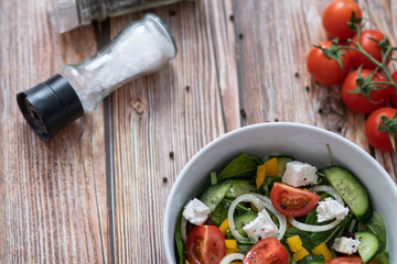 Green vegan salad made from a mixture of green leaves and vegetables.