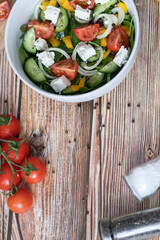 Green vegan salad made from a mixture of green leaves and vegetables.