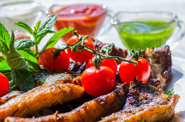 Fresh, homemade grilled beef skewers with vegetables and spices, with barbecue sauce and ketchup,...
