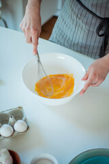 Young beautiful woman bakes a cake. Sweets. Confectionery.