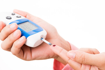 Closeup hands woman measur glucose test level check with blood on finger by glucometer she monitor...