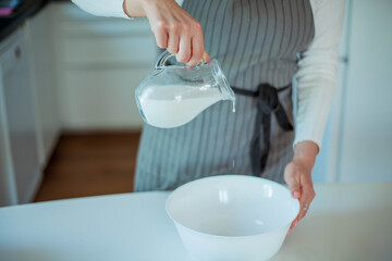 Young beautiful woman bakes a cake. Sweets. Confectionery.