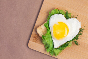 Heart-shaped scrambled eggs and toast, breakfast for loved one on valentine's day