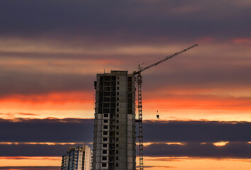 Builder workers during formworks and pouring concrete through a сoncrete pump truck connected to a...
