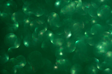 Green glitter vintage lights background. Defocused. Close-up