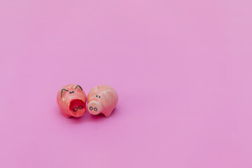Two figurines of pigs on a pink background. Composition for Valentine's Day. Flat lay, copy space,...