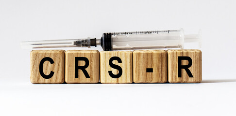 Text CRS-R made from wooden cubes. White background