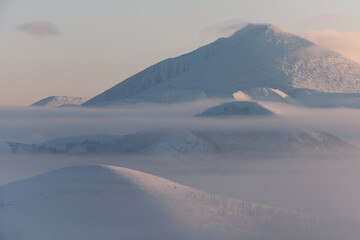 Fog on the Olchansky pass in the Oymyakonsky district. Morning landscape of snow-capped mountains. Foggy landscape of the coldest place on Earth - Oymyakon - 406668857