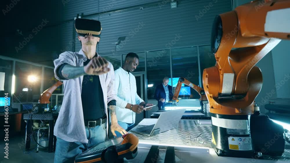 Wall mural researchers are using vr-glasses to work with robots in a modern industrial robots lab.