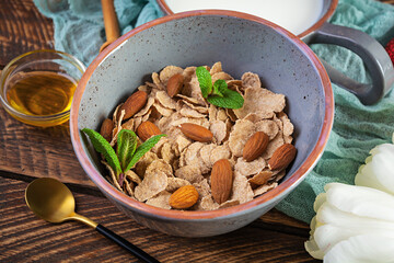 Spelt flakes with milk on breakfast. Light breakfast on Valentine's day with tulips and heart