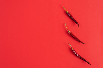 Dried red chili pepper on red background. Texture of isolated chili peppers