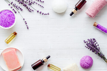 Fototapeta na wymiar Frame of lavender bath salt and essential oil, top view