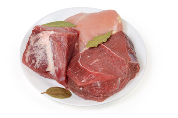 Different uncooked boneless meat on dish on a white background