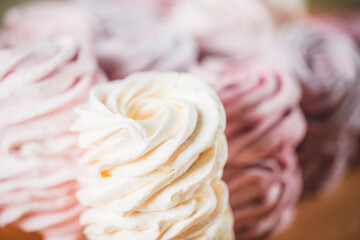 Background from multi-colored zephyr located in a row. Tea drinking concept. Confectionery decoration. Place for text