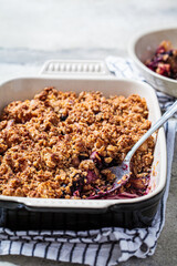 Homemade berry oat crumble pie in backing dish. Comfort food concept.