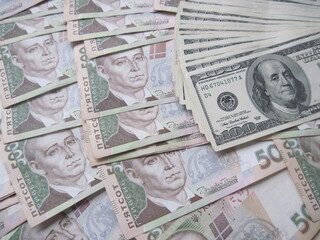 Financial background with a lot of paper banknotes of Ukrainian 500 hryvnia and 100 dollars is great for editorial publication about money exchange. 