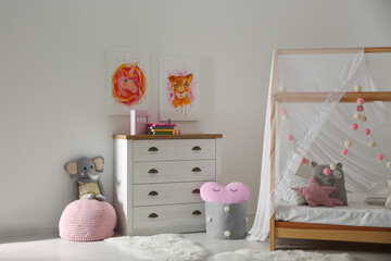 Cute pictures and and stylish furniture in baby room interior