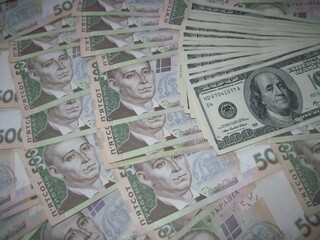 Financial background with a lot of paper banknotes of Ukrainian 500 hryvnia and 100 dollars is great for editorial publication about money exchange. 