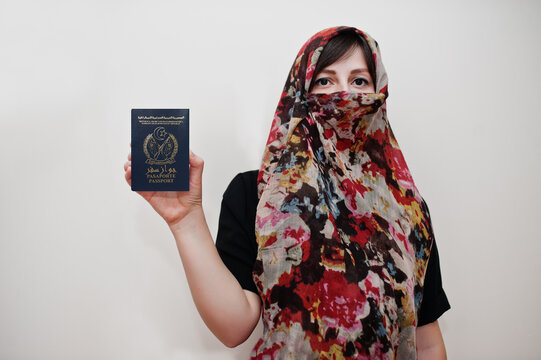 Young arabian muslim woman in hijab clothes hold Sahrawi Arab Democratic Republic passport on white wall background, studio portrait.