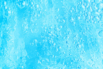 blue transparent clean drinking water abstract background. water surface with air bubbles background