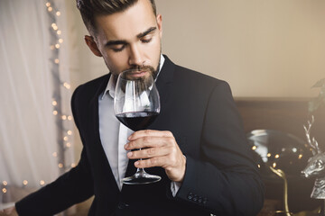 Handsome bearded man with a glass of red wine