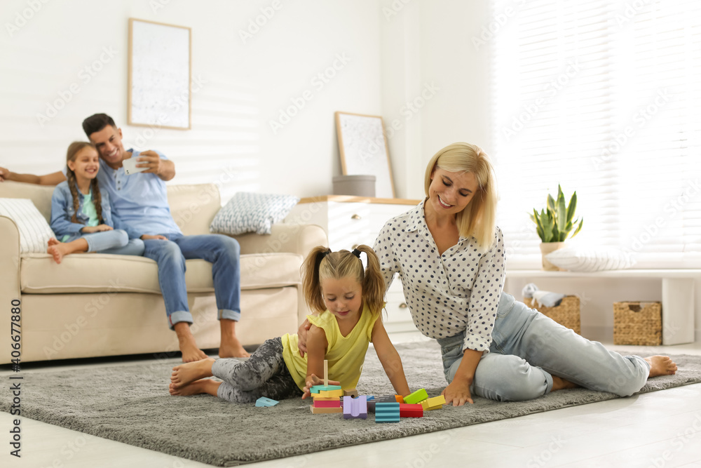 Wall mural Happy family spending time together at home