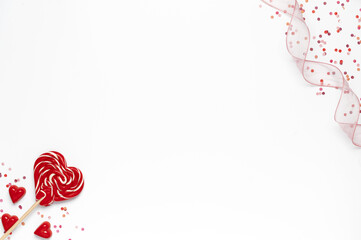 Valentine's day background with heart lollipop, confetti and ribbon on white background
