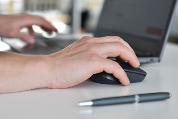 Businessman hands working in office with laptop.