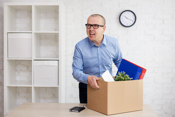 angry screaming businessman in the office with moving box