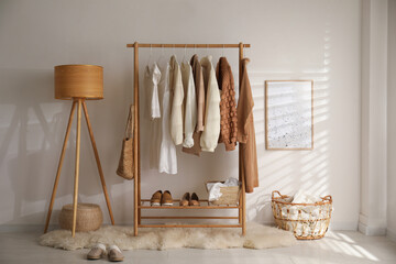 Modern dressing room interior with rack of stylish shoes and women's clothes - obrazy, fototapety, plakaty