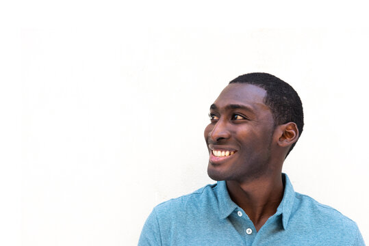 Close up smiling young black man by isolated white background looking away