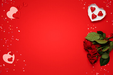 Valentine day. Bunch of roses, hearts shape, chocolate candy on red background