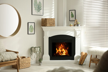 Bright living room interior with artificial fireplace and firewood in basket - obrazy, fototapety, plakaty