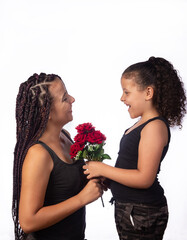 Mother and daughter dressed alike in a very happy rehearsal, white background, selective focus.