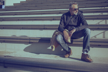 Man sitting on stairs, urban scenery