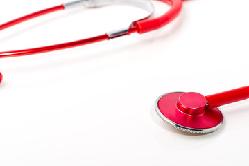 Red stethoscope on white background, close up