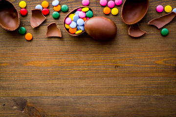 Happy Easter flat lay of chocolate eggs and sweets, top view