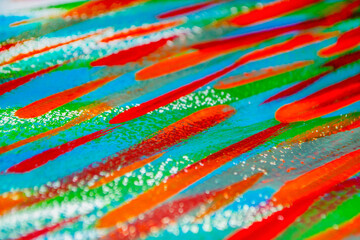 Bright varied background of colored lines of brush strokes made with paint