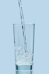 Pouring water. Pouring fresh clean drinking water to glass.