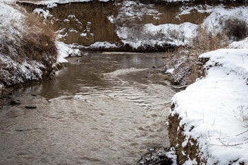 Winter river with snow on the banks